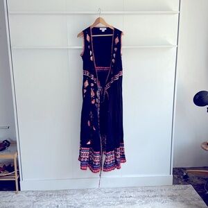 Lightweight, wrap silhouette with tie closure at waist. Embroidered pattern.